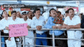 a group of men are holding signs that say welcome to mr award .