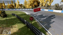 a stop sign is on the side of a race track in a video game