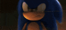 a close up of a cartoon character , sonic the hedgehog , running on a wooden floor .