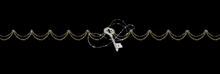 a key is hanging from a string of gold beads