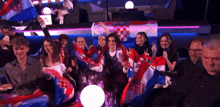 a group of people holding flags in front of a flag that says croatia
