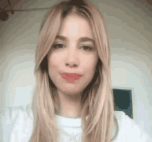 a close up of a woman 's face with long blonde hair