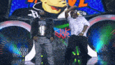 two men are dancing in front of a sign that says nikki