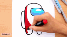 a person is drawing an among us character with a marker