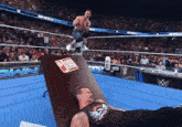 a man in a wrestling ring with a sign that says jim on it
