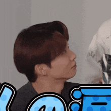 a close up of a person 's face with the word love behind him