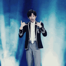 a man in a suit and tie with the letter s on the jacket