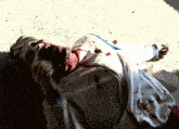 a man laying on the ground with blood coming out of his mouth