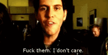 a close up of a man 's face with the words " fuck them , i don 't care . "