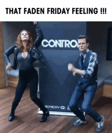 a man and woman are dancing in front of a sign that says contro