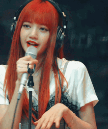 a woman wearing headphones singing into a microphone