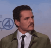 a man with a mustache is wearing a green jacket and a tie