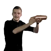 a man in a black shirt is shaking a bottle
