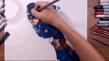 a person is drawing captain america with a pencil