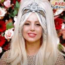 a woman with blonde hair and a crown on her head is smiling
