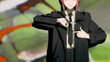 a girl in a suit and tie is pointing to her chest
