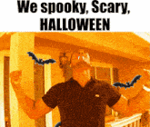 a man with bats in his mouth is standing in front of a house with the words we spooky scary halloween
