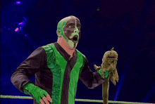 a man with green paint on his face is holding something