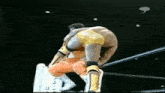 two wrestlers are wrestling in a ring and one is wearing orange shorts and yellow boots .