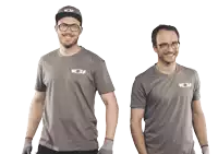two men wearing gray shirts with wolf on the front