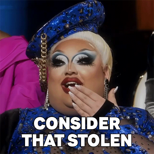 a drag queen is wearing a blue outfit and covering her mouth with her hand and the words consider that stolen above her