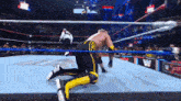 a wrestler with gn on his shorts is kneeling on the floor