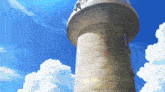 a brick tower with a blue sky and clouds behind it