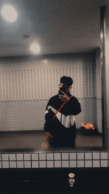 a man taking a selfie in front of a mirror