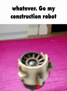 a robot is sitting on top of a pink rug .