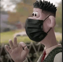 a cartoon character wearing a black face mask is waving .