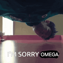 a man is upside down and says i 'm sorry omega on the floor .