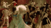 a group of drag queens are dancing in a room with a red carpet .