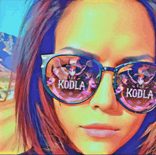 a woman wearing sunglasses with the word koda written on them