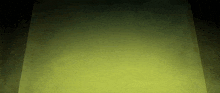 a dark room with a yellow light coming out of it