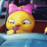 a cartoon duck with a pink bow is looking at a phone
