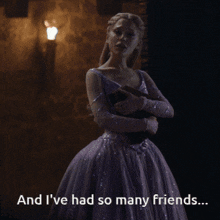 a woman in a purple dress is holding a book and says " and i 've had so many friends "