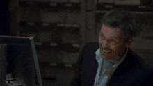a man sitting in front of a computer with the words " i knew it " on the bottom