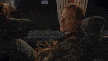 a man sits on a bus with a 2hd logo on the bottom right