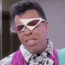 a close up of a man wearing sunglasses and a scarf
