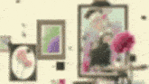 a blurry picture of a woman sitting on an easel in front of a painting .