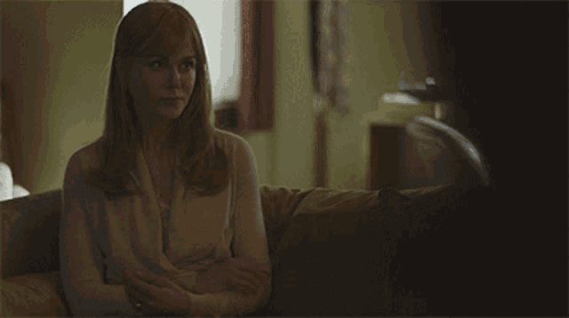 a woman is sitting on a couch and says perhaps my self worth is made up of how other people see me