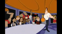 a group of people are gathered around a table with a man holding a basketball in front of them