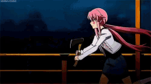 a girl with pink hair is fighting a monster with a large eye .