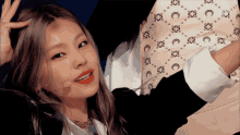 a woman wearing a white shirt with a pattern of crescent moons and flowers