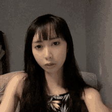 a woman with long black hair takes a selfie