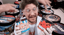 a man wearing goggles is holding a can that says ' wolf ' on it