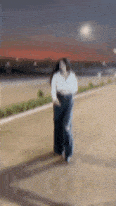 a blurry picture of a woman running down a street .