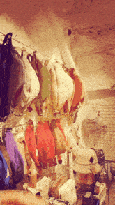 a bunch of hats are hanging on a rack with one that says ' a ' on it