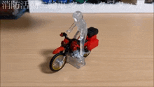 a toy motorcycle is on a wooden table with chinese writing on it