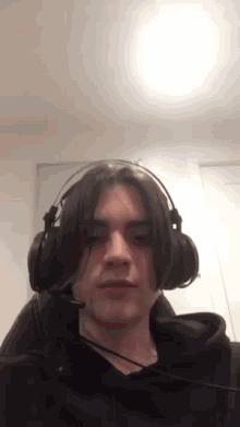 a young man is wearing headphones and a microphone .